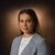Professional portrait: woman in gray blazer and white top with necklace, brown gradient background