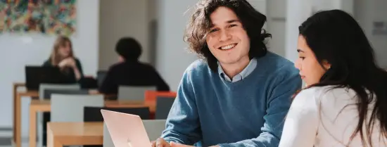 smiling EUC student with a laptop 