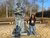 Hima Varshini looks into the camera while standing next to the Erasmus statue on Campus Woudestein.