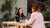 Two students talking to each other at a cafe