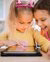 2 girls on an ipad