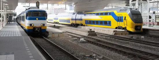Two NS trains at a Dutch train station.