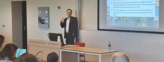 Guido Imbens presenting in front of a classroom of people