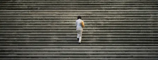 Person in white suit walking on staircase