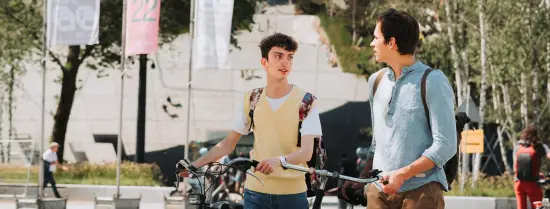 Students walk bikes around town.